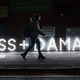 A woman walks by a lit sign in Glasgow on November 4, 2021 at last year’s COP.